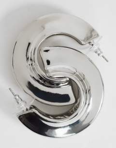 Model wearing Cassie chunky hoop earrings in silver tone