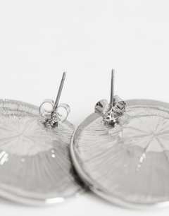 Model wearing Cece statement round stud earrings in silver tone