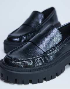 Model wearing Cecil chunky cleated sole loafer in black 