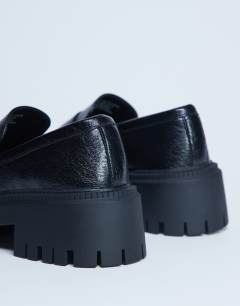 Model wearing Cecil chunky cleated sole loafer in black 