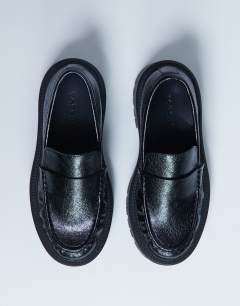Model wearing Cecil chunky cleated sole loafer in black 