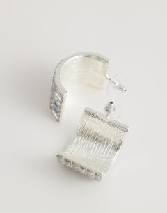 Model wearing Celeste diamante hoop earrings in silver