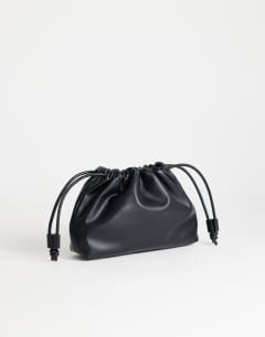 Model wearing Celia medium ruched clutch bag in black
