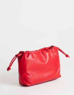 Model wearing Celia medium ruched clutch bag in red