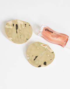 Model wearing Chantal large statement disc earrings in gold tone