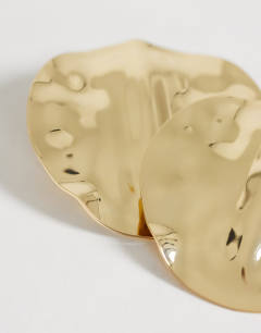 Model wearing Chantal large statement disc earrings in gold tone