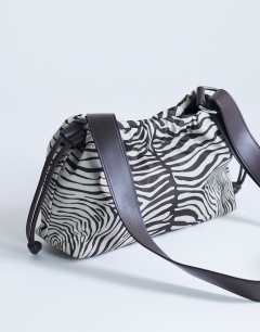 Model wearing Charlie medium nylon cross body bag in zebra