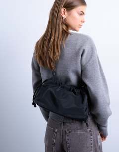 Model wearing Charlie nylon cross body bag in black 
