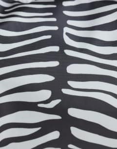 Model wearing Charlie nylon cross body bag in zebra
