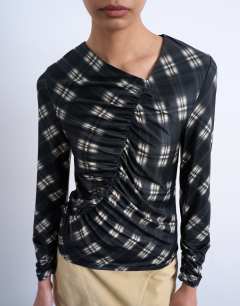 Model wearing Check print ruched asymmetric long sleeve top in black