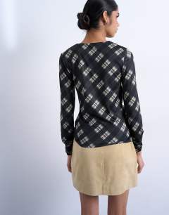 Model wearing Check print ruched asymmetric long sleeve top in black