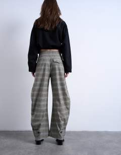 Model wearing Check tailored barrel leg trouser
