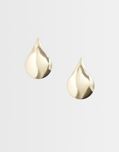 Model wearing Cher statement teardrop stud earrings in gold tone