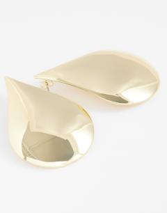 Model wearing Cher statement teardrop stud earrings in gold tone