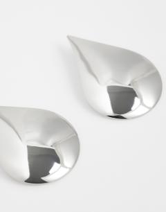 Model wearing Cher statement teardrop stud earrings in silver tone
