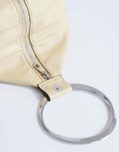 Model wearing Cherry metal handle grab bag in buttermilk