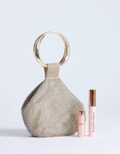 Model wearing Cherry small metal handle grab bag in gold diamante