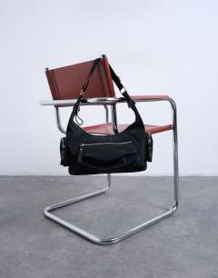 Model wearing Cheryl large nylon crossbody bag in black