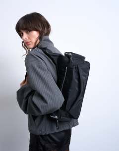 Model wearing Cheryl large nylon crossbody bag in black