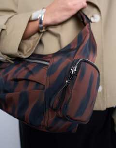 Model wearing Cheryl large nylon crossbody bag in leopard