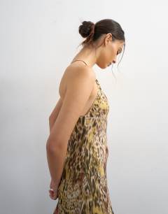 Model wearing Chiffon cut away racer neck full skirt maxi dress in abstract animal
