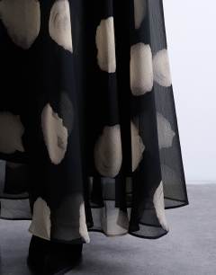 Model wearing Chiffon full maxi skirt in mono spot print