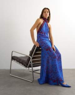 Model wearing Chiffon halter neck tucked side maxi dress in blue and burgundy abstract print