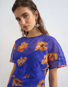 Model wearing Chiffon maxi dress with pintucks detail in purple and orange floral