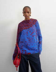 Model wearing Chiffon overlay detail blouse in blue mixed print