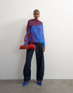 Model wearing Chiffon overlay detail blouse in blue mixed print