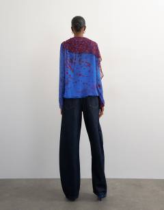 Model wearing Chiffon overlay detail blouse in blue mixed print