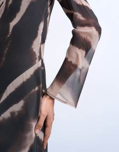 Model wearing Chiffon scoop neck column maxi dress in blurred animal print