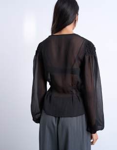 Model wearing Chiffon sheer panel long sleeve blouse in black