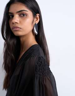 Model wearing Chiffon sheer panel long sleeve blouse in black