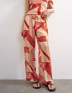 Model wearing Chiffon stripe print wide leg trouser co-ord in red