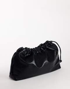 Model wearing Chloe oversized ruched pouch clutch bag in black