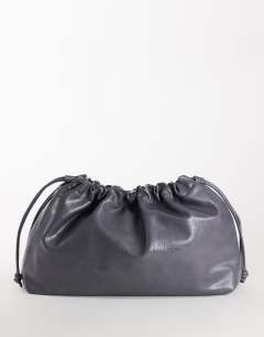 Model wearing Chloe oversized ruched pouch clutch bag in grey
