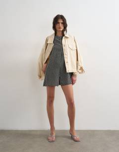 Model wearing Chuck on boxy playsuit in mono check