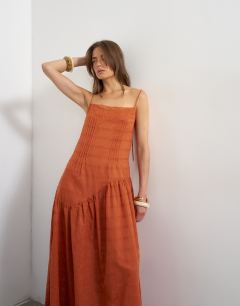 Model wearing Chuck on maxi dress in orange