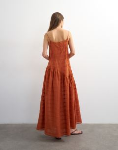 Model wearing Chuck on maxi sundress in orange