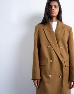 Model wearing Chuck on tailored 6 button formal coat in tan