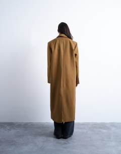 Model wearing Chuck on tailored 6 button formal coat in tan