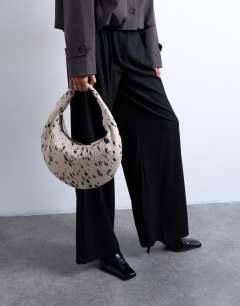 Model wearing Cian hair on real suede scoop grab bag in dalmatian print