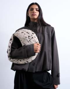 Model wearing Cian real suede scoop grab bag in dalmatian