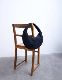 Model wearing Cian real suede scoop grab bag in navy