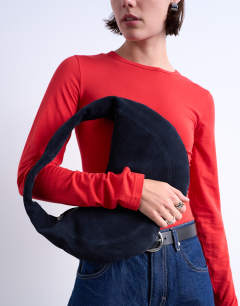 Model wearing Cian real suede scoop grab bag in navy