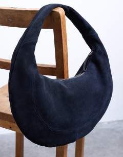 Model wearing Cian real suede scoop grab bag in navy