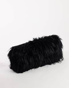 Model wearing Ciara oversized folded faux fur structured clutch bag in black