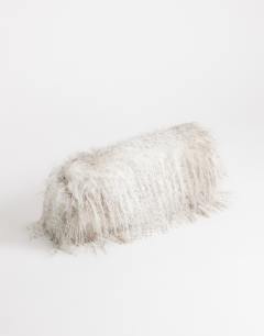 Model wearing Ciara oversized folded faux fur structured clutch bag in neutral mix