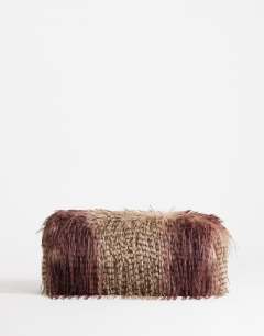 Model wearing Ciara oversized large folded faux fur structured clutch bag in burgundy mix